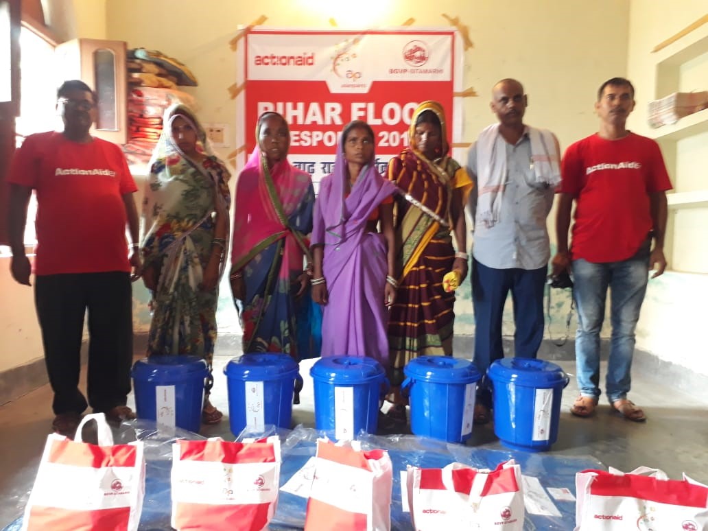 ActionAid team distributing buckets. Blankets to the affected people